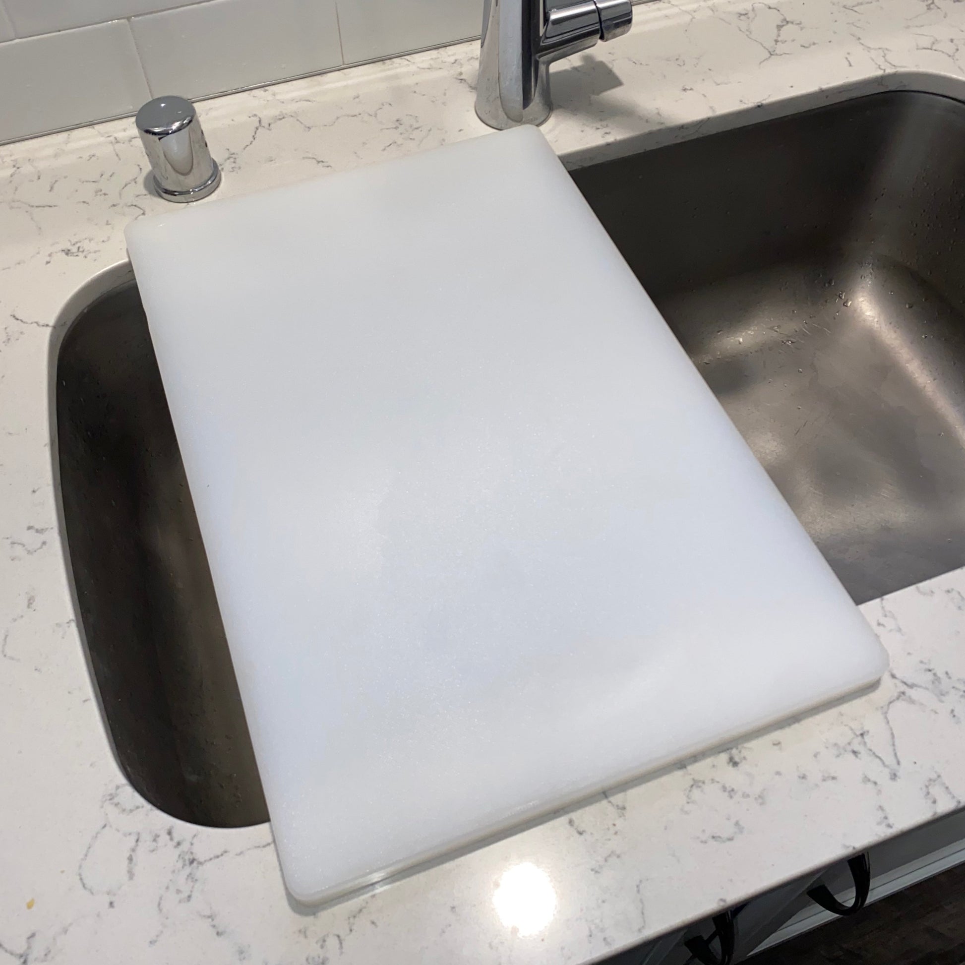 White SinkBoard shown in position over undermount sink.